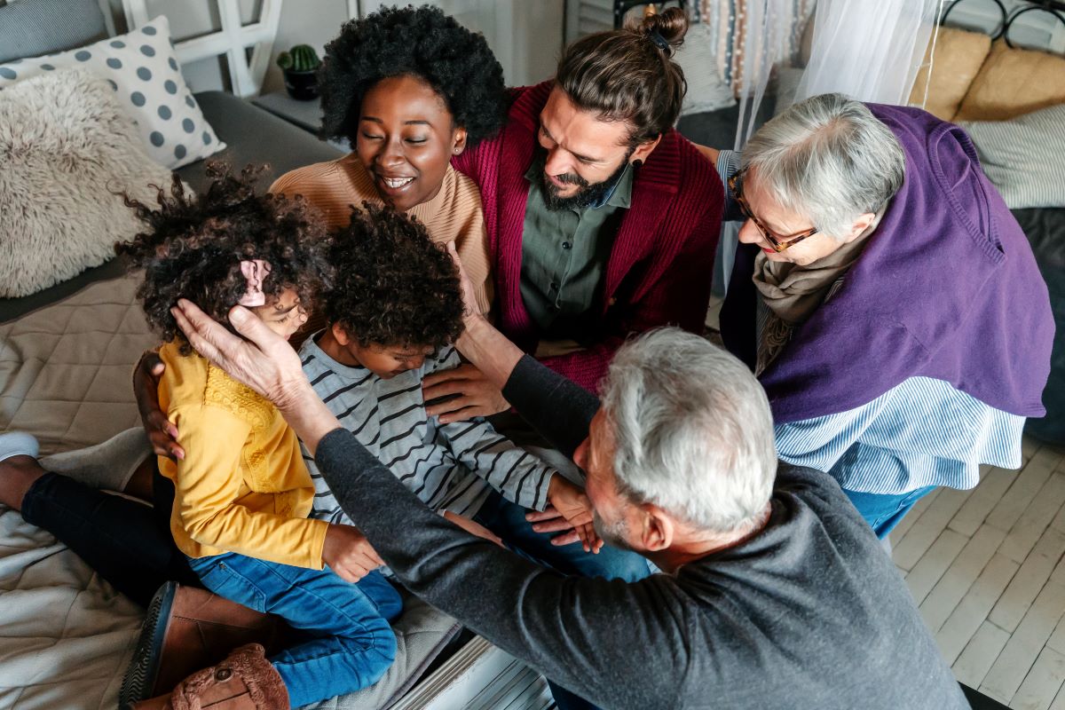 Three generational happy multiethnic family enjoying time together at home